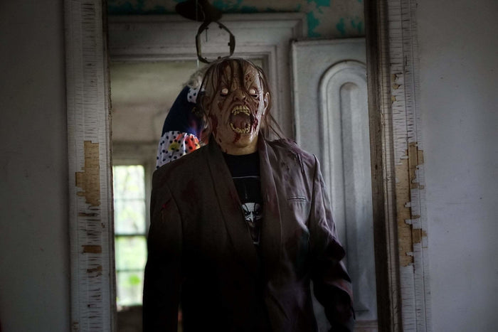 The Horror Dome's Dead Awake mask worn with tattered clothing for seamless horror