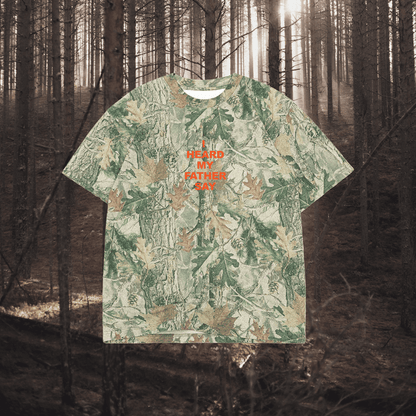 Camouflage-patterned t-shirt with text in a forest setting
